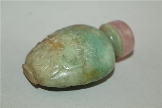 A Chinese pale green and russet jadeite snuff bottle, 1880-1930, 5.9cm